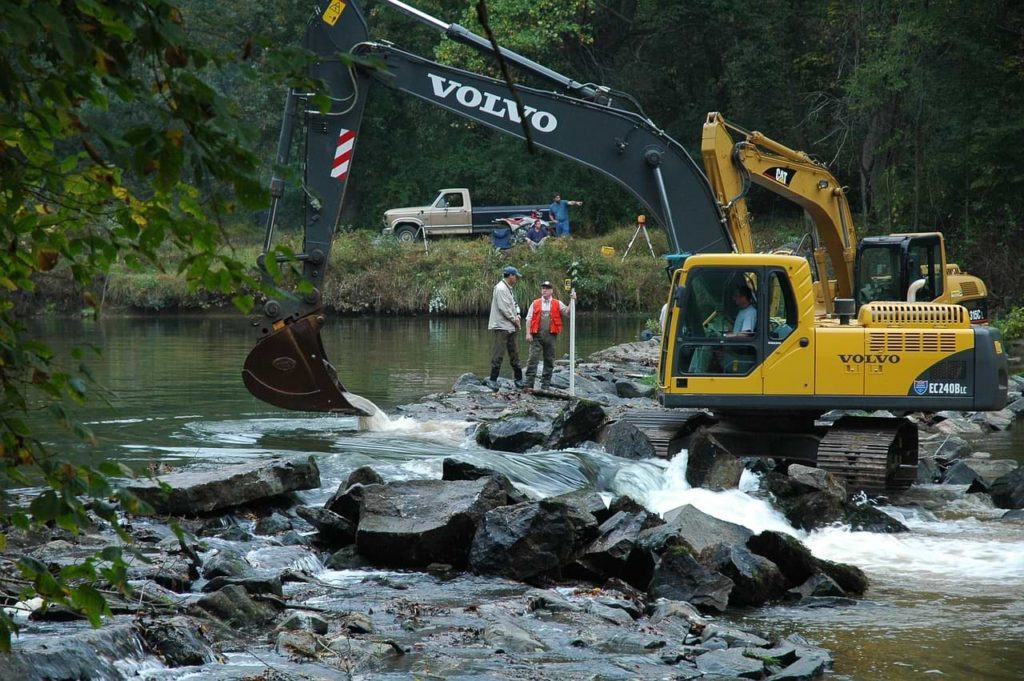 backhoe loader in river